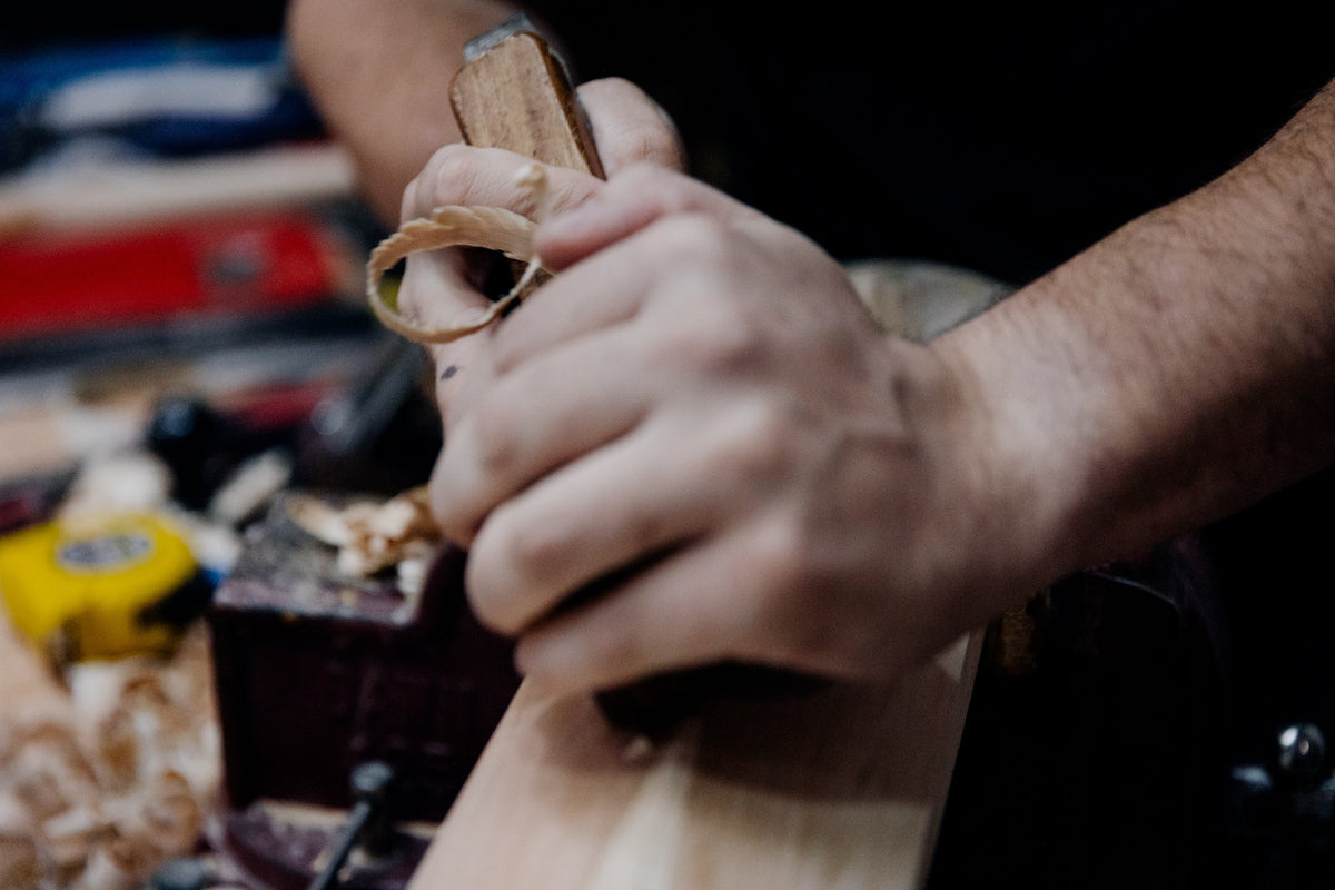 Knocking in a handcrafted cricket bat at the JPGavan workshop in Sydney