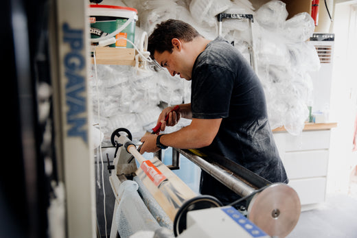 Bat maker fitting a new handle on the lathe at JPG HQ