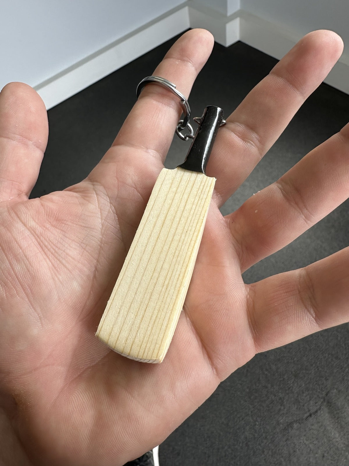 JPGavan mini keychain cricket bat in hand, showing its size